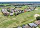 This aerial view of a community features beautiful homes along a golf course. The home is marked with a red star at 11702 Se 173Rd Lane Rd, Summerfield, FL 34491