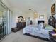 A spacious bedroom provides generous closet space and sliding glass door with access to the outside at 11702 Se 173Rd Lane Rd, Summerfield, FL 34491