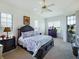 This bright bedroom features a ceiling fan, large windows, and comfortable furnishings at 11702 Se 173Rd Lane Rd, Summerfield, FL 34491