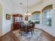 Dining area featuring a glass table, hardwood floors, and decorative accents at 11702 Se 173Rd Lane Rd, Summerfield, FL 34491