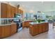 Well-lit kitchen with wood cabinetry, stainless appliances, and a functional island at 11702 Se 173Rd Lane Rd, Summerfield, FL 34491