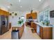 Spacious kitchen with stainless appliances, center island, and tile flooring at 11702 Se 173Rd Lane Rd, Summerfield, FL 34491