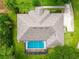 Overhead shot of a home with a swimming pool, nice yard, and driveway at 11811 Ridge View Cir, Clermont, FL 34711