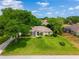 Aerial view of the residence and its surrounding landscape, including lush greenery at 11811 Ridge View Cir, Clermont, FL 34711
