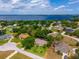 Aerial view of a residential neighborhood near a beautiful lake with mature trees and well-maintained lawns at 11811 Ridge View Cir, Clermont, FL 34711