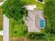 Birds eye view of a home with lush landscaping, a swimming pool, and a driveway with parking at 11811 Ridge View Cir, Clermont, FL 34711