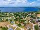 An aerial view shows a lakeside neighborhood with mature landscaping and homes with private pools at 11811 Ridge View Cir, Clermont, FL 34711