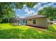 Backyard view with screened pool, grassy area, and privacy landscaping at 11811 Ridge View Cir, Clermont, FL 34711