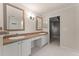 Bathroom showing a double sink vanity, an arched doorway and lighting at 11811 Ridge View Cir, Clermont, FL 34711
