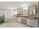 Bright bathroom with a glass door shower, soaking tub, and double sink vanity with white cabinets at 11811 Ridge View Cir, Clermont, FL 34711