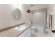 Bathroom features a shower-tub, single vanity, and mirror at 11811 Ridge View Cir, Clermont, FL 34711