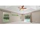 Bright bedroom with pool view, tray ceiling, and fan at 11811 Ridge View Cir, Clermont, FL 34711