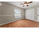 Bedroom with laminated wood flooring, natural light, and closet at 11811 Ridge View Cir, Clermont, FL 34711