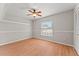 The bedroom has wood floors, a large window, and a ceiling fan at 11811 Ridge View Cir, Clermont, FL 34711