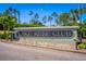 Well-maintained Lake Ridge Club sign with decorative rock and lush landscaping at 11811 Ridge View Cir, Clermont, FL 34711