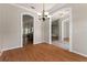 Bright dining room with hardwood floors, arched doorways and an elegant chandelier at 11811 Ridge View Cir, Clermont, FL 34711