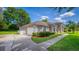 This home showcases a clean two-car garage and a well-manicured front yard with lush plantings at 11811 Ridge View Cir, Clermont, FL 34711