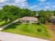 Attractive home featuring a well-kept lawn, mature trees, and manicured landscaping at 11811 Ridge View Cir, Clermont, FL 34711
