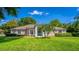 Well-kept home with lush green lawn and mature landscaping enhances curb appeal at 11811 Ridge View Cir, Clermont, FL 34711