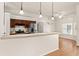 An open concept kitchen boasts stainless appliances and wood cabinetry, with pendant lighting and a breakfast bar at 11811 Ridge View Cir, Clermont, FL 34711
