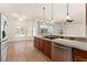 Bright eat-in kitchen with wood cabinets, stainless appliances, breakfast bar and backyard views at 11811 Ridge View Cir, Clermont, FL 34711