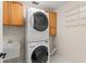 Laundry room with a stackable washer, dryer, and cabinetry at 11811 Ridge View Cir, Clermont, FL 34711