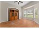 A living room features an arched alcove, a cabinet, and a ceiling fan at 11811 Ridge View Cir, Clermont, FL 34711