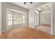 This living room features a bay window, a transom window, and wood floors at 11811 Ridge View Cir, Clermont, FL 34711