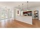 Bright and open-concept living area with kitchen views and access to the front door at 11811 Ridge View Cir, Clermont, FL 34711