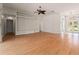 Open-concept living room with hardwood floors, built-in shelving, and lots of natural light at 11811 Ridge View Cir, Clermont, FL 34711