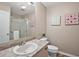 Well-lit bathroom with granite countertop vanity and glass-enclosed shower at 1203 Zapata Pl, The Villages, FL 32159