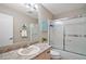 Clean bathroom with vanity and shower featuring a sleek glass door and modern lighting at 1203 Zapata Pl, The Villages, FL 32159