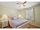 Inviting bedroom with a ceiling fan, window with curtains, and two bedside tables at 1203 Zapata Pl, The Villages, FL 32159