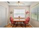 Charming dining area features wood table set and bright natural light from the windows at 1203 Zapata Pl, The Villages, FL 32159