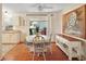 Bright dining area with white table, stylish chairs, and view to the backyard at 1203 Zapata Pl, The Villages, FL 32159