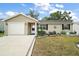 Charming single-story home featuring a well-maintained lawn and attached one car garage at 1203 Zapata Pl, The Villages, FL 32159
