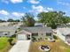 Charming home with a well-manicured lawn, a two-car garage and delightful landscaping at 1203 Zapata Pl, The Villages, FL 32159