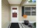 Inviting front entrance with a storm door and decorative landscaping at 1203 Zapata Pl, The Villages, FL 32159