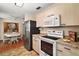 Modern kitchen featuring updated appliances and light wood cabinets at 1203 Zapata Pl, The Villages, FL 32159