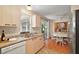 Well-lit kitchen featuring light wood cabinets and backyard access at 1203 Zapata Pl, The Villages, FL 32159