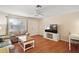 Well lit living room with hardwood floors, neutral walls and backyard access at 1203 Zapata Pl, The Villages, FL 32159