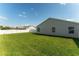 Spacious backyard featuring well-maintained lawn and a white privacy fence, providing a secure and pleasant outdoor space at 12054 Ne 51St Cir, Oxford, FL 34484