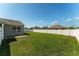 Expansive backyard featuring well-maintained lawn and white privacy fence, perfect for outdoor activities and relaxation at 12054 Ne 51St Cir, Oxford, FL 34484