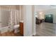 Bathroom with tub, toilet, and vanity with sink, adjacent to living room at 12054 Ne 51St Cir, Oxford, FL 34484