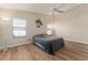 Bright bedroom with ceiling fan, two windows and laminate wood floor at 12054 Ne 51St Cir, Oxford, FL 34484