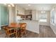 Dining area with wood table and access to kitchen featuring wood cabinets at 12054 Ne 51St Cir, Oxford, FL 34484