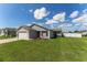 Charming single-story home with a well-manicured lawn and a fenced backyard, perfect for relaxation and outdoor activities at 12054 Ne 51St Cir, Oxford, FL 34484