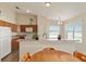 Kitchen view with wood cabinets and breakfast bar overlooking the dining area at 12054 Ne 51St Cir, Oxford, FL 34484