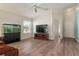 Bright living room with hardwood floors, aquarium, and access to the front entrance at 12054 Ne 51St Cir, Oxford, FL 34484