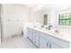 Spacious bathroom with double vanity, large mirror, and great natural light at 12196 Ne 4Th Pl, Oxford, FL 34484